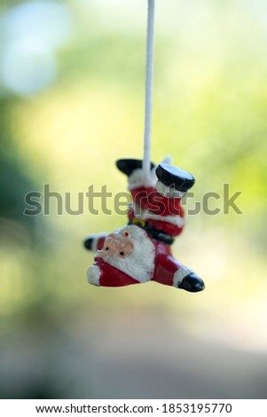 Santa Claus hanging by a rope