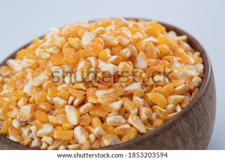 Under the background of white a bowl of corn kernels