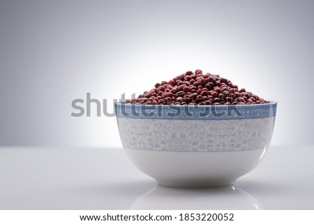 Under the background of grey a bowl of red bean