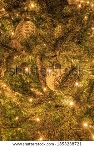 Nice detail picture of a part of a Christmas tree with Christmas decorations. Christmas 2020.
