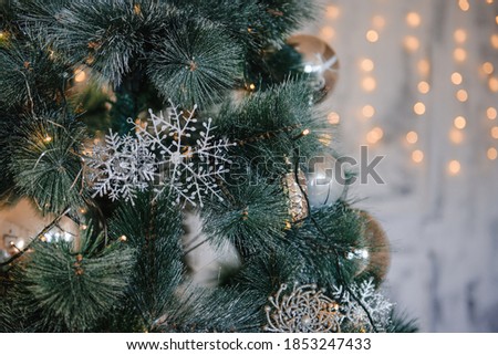 background, Christmas tree decorated with silver toys and garland