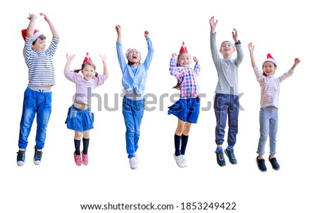happy kids  jumping and celebrating christmas isolated on white