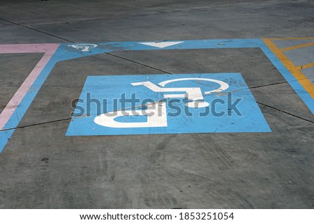 A channel blue parking sign for wheelchair in the carpark.