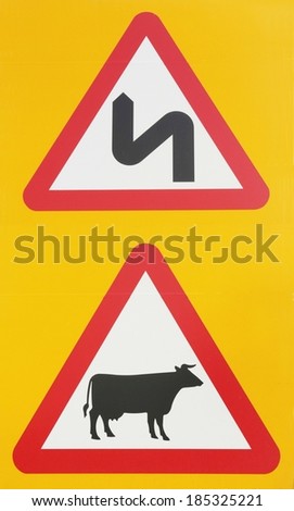 Double Bend sign and cattle warning road sign against a yellow background.
