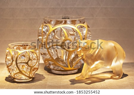 Gilded decorative bear figurine and glass flower vases - Home decor item. Royalty-Free Stock Photo #1853255452