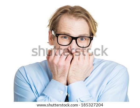 Closeup portrait, nerdy young guy with black glasses biting his nails, looking funny, scared, craving something, anxious, isolated white background. Human facial expressions, emotions, feelings