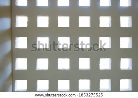 Square hole wall with white outdoor background