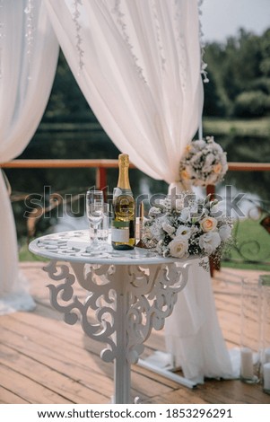wedding decor
glasses and bottle of champagne on the white table