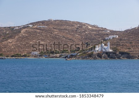 View of the Agia Irini, Saint Irene, Greek Orthodox church from Tzamaria Beach. Hills in the background.