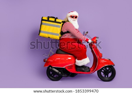 Photo of santa claus drive scooter wear backpack x-mas costume headwear glasses isolated purple color background