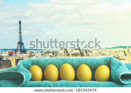 Easter decoration with Paris cityscape and Eiffel Tower in the background. Eggs and Turkish towel.