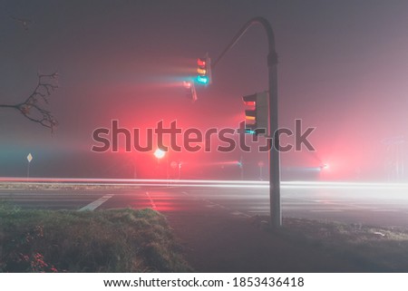 traffic lights in a foggy night, side view