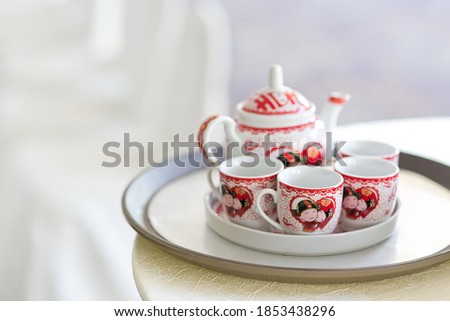 Traditional Chinese wedding with "Double Happiness" text calligraphy illustration on the tea set.