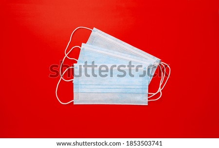 Covid-19 Surgical face mask with red background banner. Panoramic Top view, Protective face mask as prevention for corona virus. wear a face mask with compulsory wearing corona virus prevention.