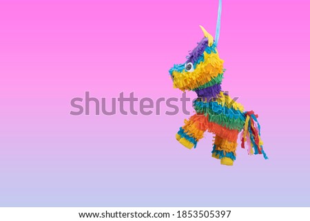 
christmas pink piñata, birthday piñata, colorful, blue background with bright lights, celebration, party, kids, candy, joy, celebrating