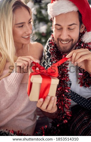 Close up of a happy couple sharing gifts on Chrismas morning at home