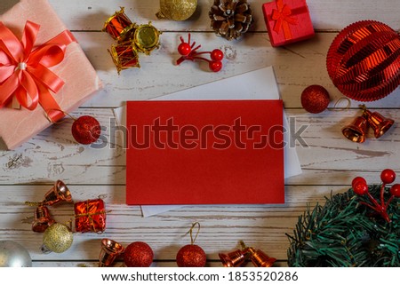 Christmas composition on a white wood background and a blank red card for writing the text. Layout Christmas background concept