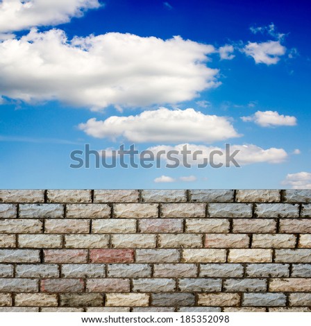 decorative  brick fence wall against blue sky