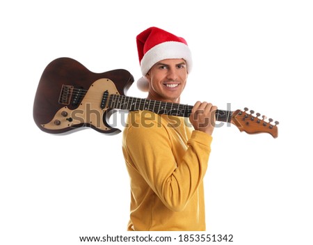 Man in Santa hat with electric guitar on white background. Christmas music