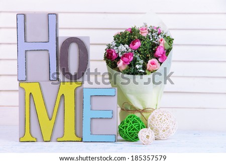 Composition with decorative letters on table on wooden background
