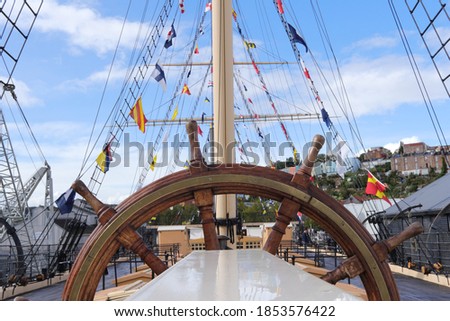Deck, masts and flags on the SS Great Britain against a blue sky Royalty-Free Stock Photo #1853576422