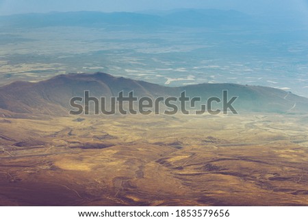 Amazing aerial view of desert,  stone hills, and distant mountains layers range.Wilderness background. Vintage toning effect. Near Mount Erciyes. Kayseri, Turkey.