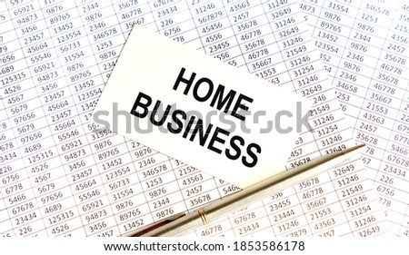 On the business card the text of HOME BUSINESS, all against the background of reports and pens.