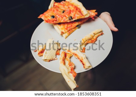 Few slices of half eaten hawaiian pizza, composition.