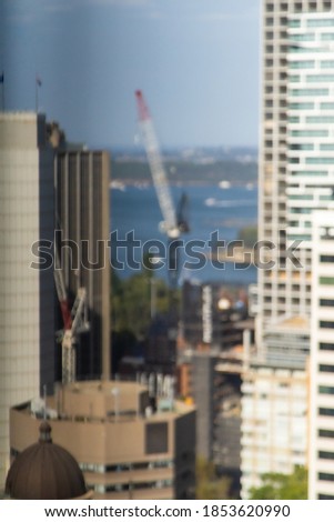Out of focus construction crane with water in background