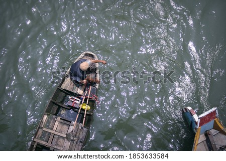 A fisherman on a boat in Mekong Delta, souther Vietnam, taken from  bird's eye view