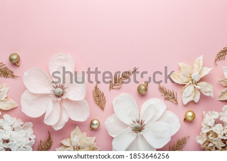 Christmas composition. Border made of christmas decoration on pink background. Flat lay, top view.