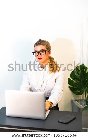 A closeup of a young successful businesswoman working on the laptop