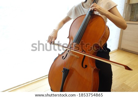 young woman playing the cello 