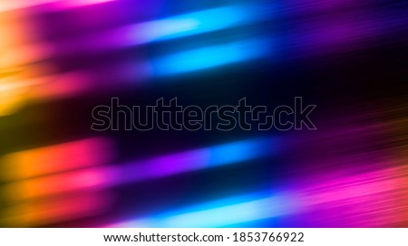 Multi-colored neon lights on a dark city street, reflection of neon light in puddles and water. Abstract night background, blurred bokeh light. Night view. Royalty-Free Stock Photo #1853766922