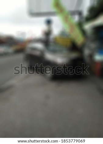 Blurred car parking beside road