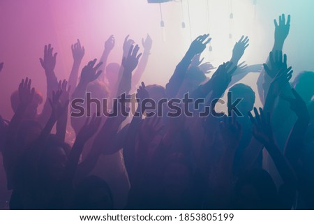 Photo of big group gather concert many funny people raise arms neon bright spotlight modern club indoors