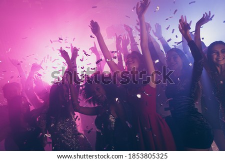 Photo of big group many classy girls falling confetti catch arms neon bright pink spotlight modern club indoors