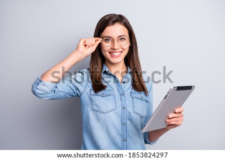 Photo of attractive lovely brown haired woman hold tablet adjust glasses university student isolated on grey color background