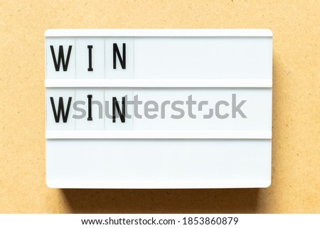 Lightbox with word win win on wood background