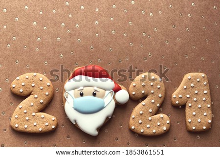 2021 wallpaper with Santa in a mask on craft background with golden dots