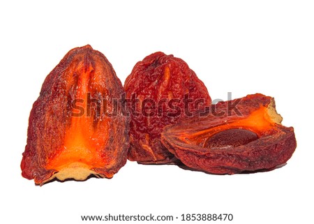 Dried persimmon cut into two halves.