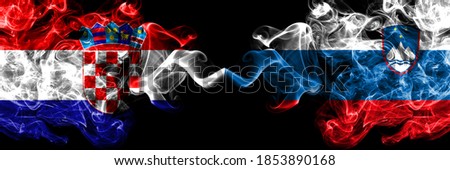 Croatia, Croatian vs Slovenia, Slovenian smoky mystic flags placed side by side. Thick colored silky abstract smoke flags.