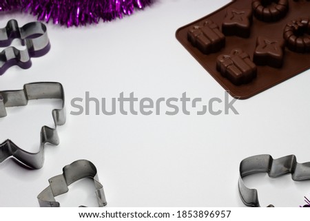 Christmas background. Molds for cookies and dark chocolate