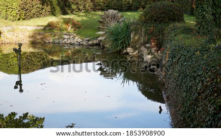 A reflection of blue sky and trees in the lake