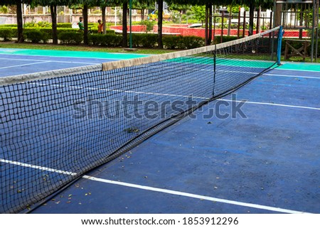 Simple tennis court outdoor in summer town. Tennis club outdoor. Summer sport and active lifestyle concept. Healthy outdoor activity. Public park sport field. Open playground