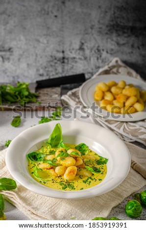 Crispy gnocchi in curry sauce with brussels sprouts