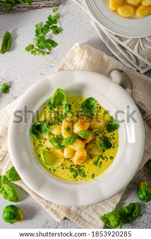 Crispy gnocchi in curry sauce with brussels sprouts