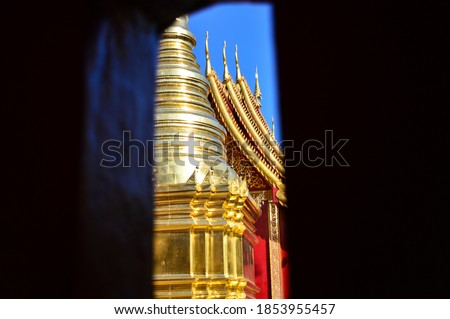 Viharn window with Lanna architecture pagoda at Wat Pa Yang (Wat San Phra Chor Daeng) in Lamphun Province, Thailand