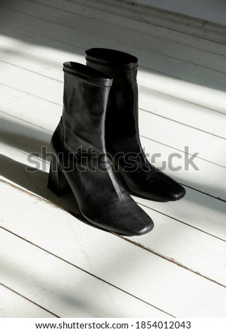 beautiful black shoes on a white wooden floor