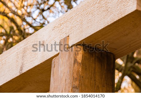 Age and new wooden beams connected, carpentry. High quality photo